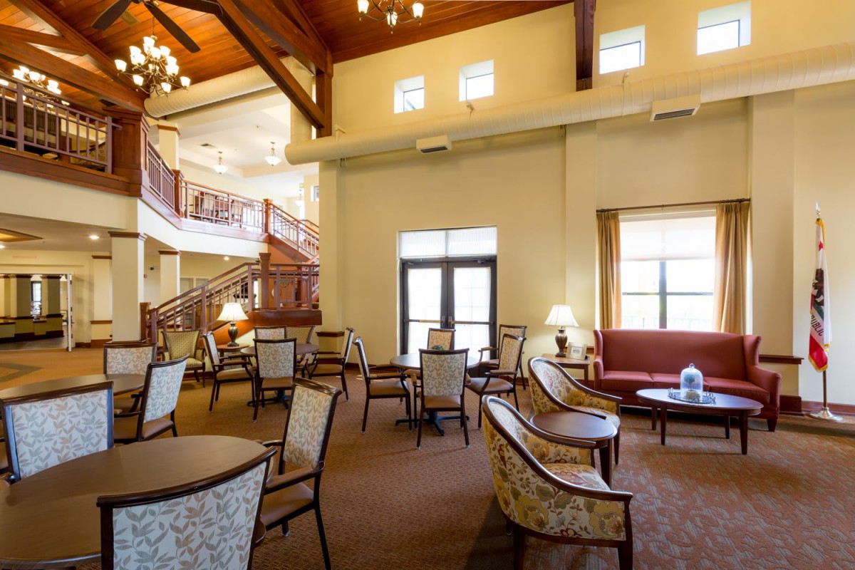 A spacious lobby with elegant seating and a staircase.
