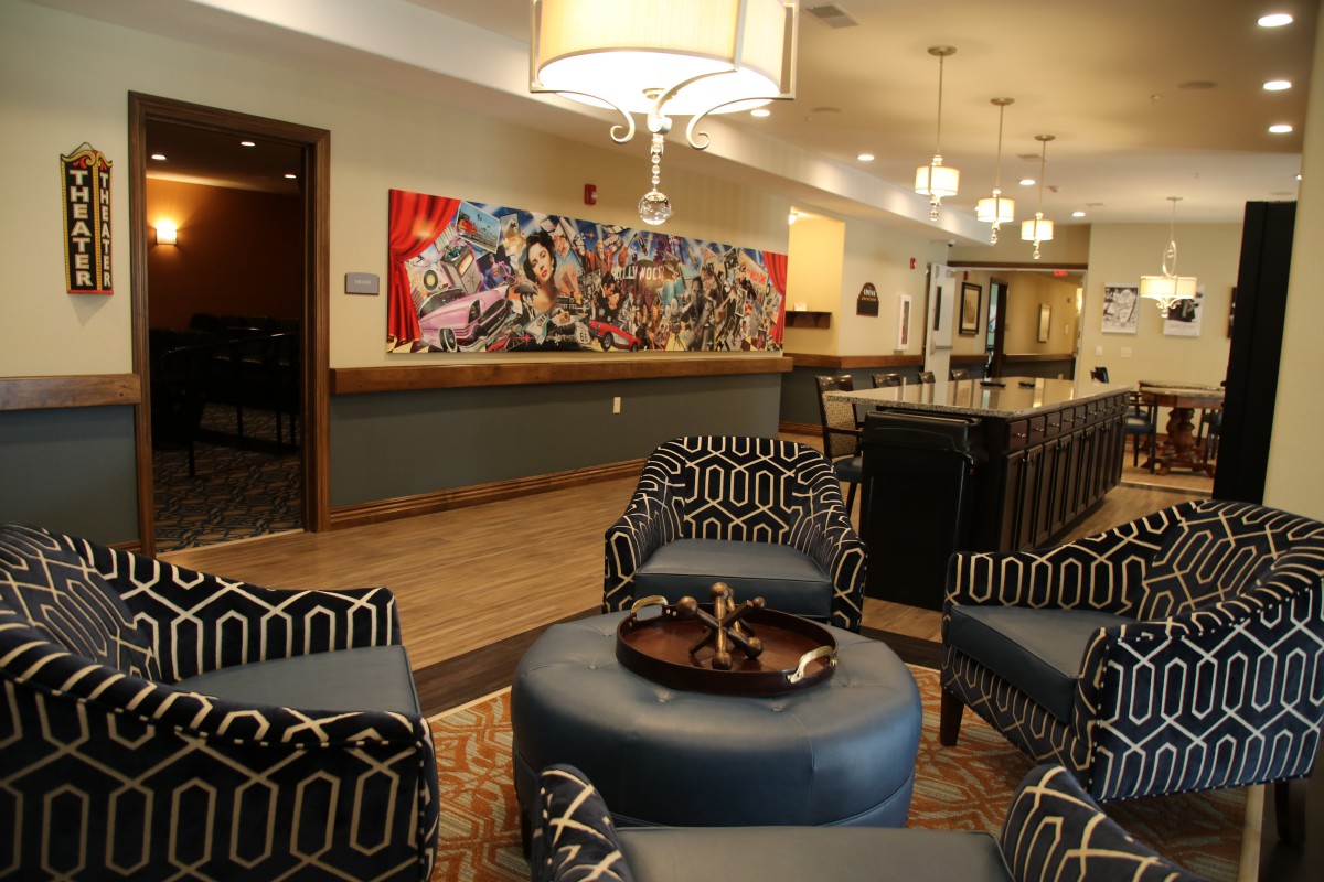 A modern lobby with stylish seating and vibrant artwork on the wall.