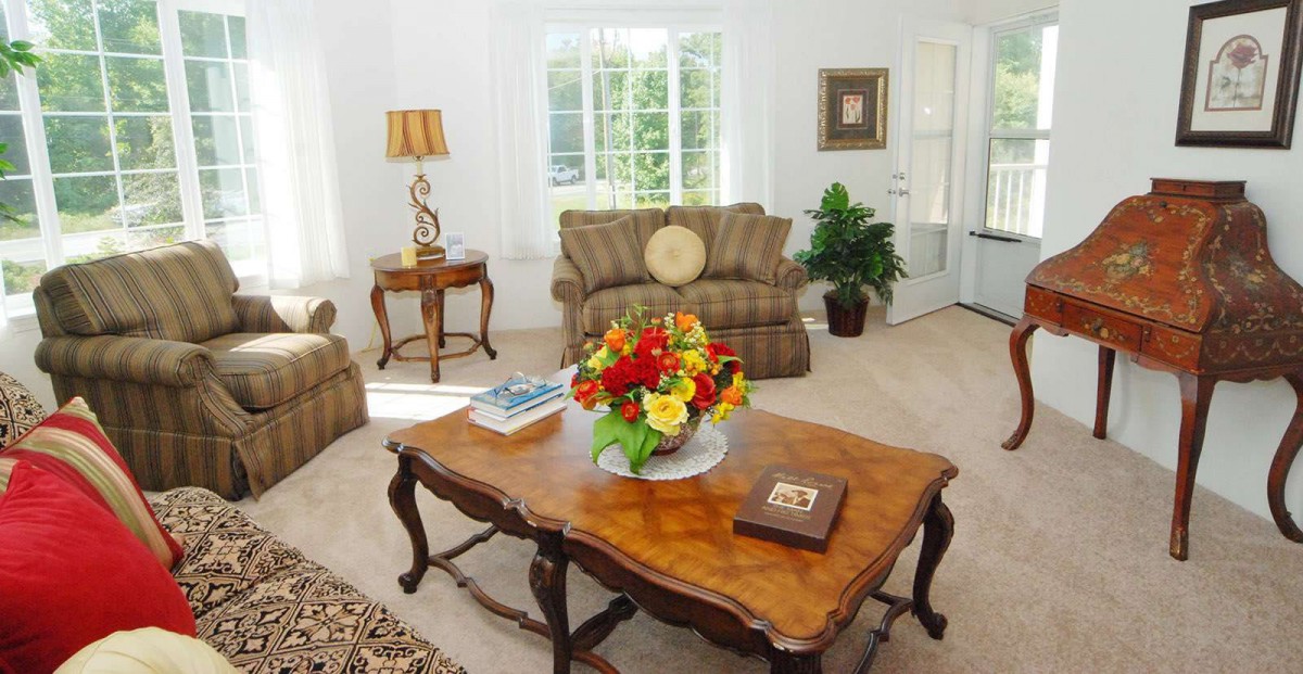 Cozy living room with elegant furniture and a floral centerpiece.