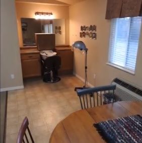 A room featuring a combined beauty salon setup and dining area.
