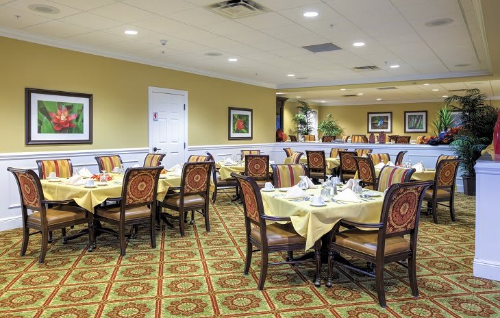A well-decorated dining room with neatly arranged tables and chairs.