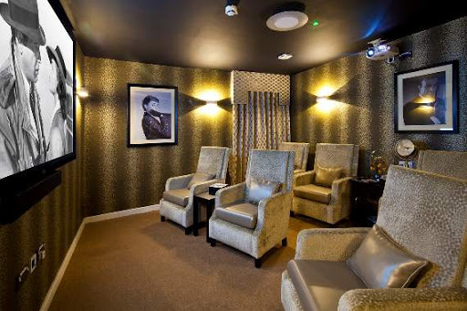 A cozy lounge area featuring comfortable upholstered chairs and ambient lighting, perfect for relaxation.