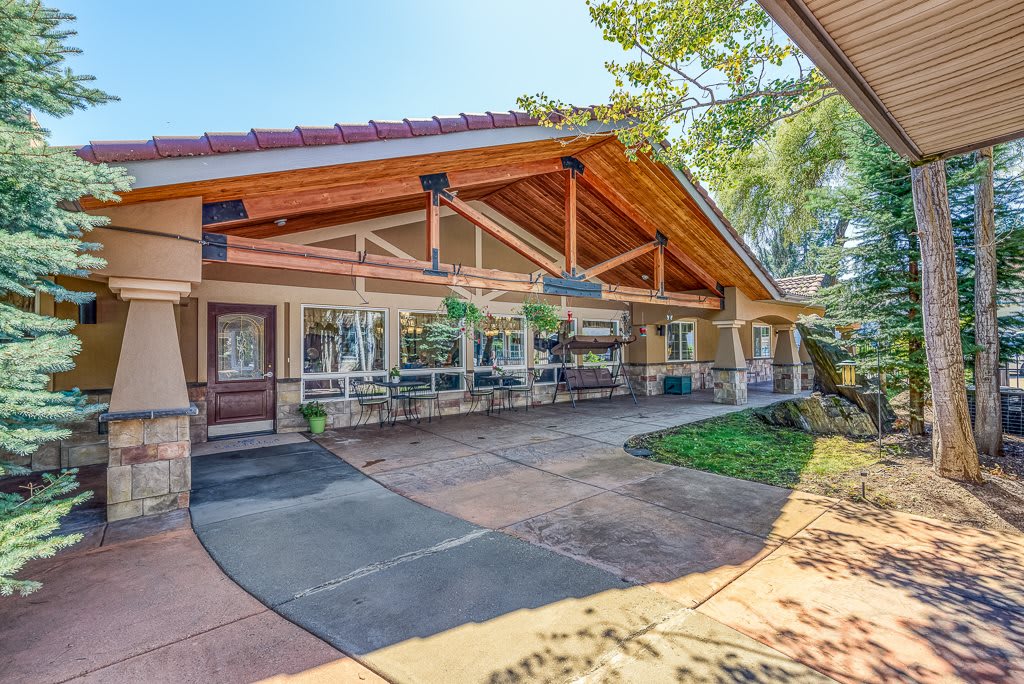 A charming house exterior with a spacious front porch and well-maintained landscaping.
