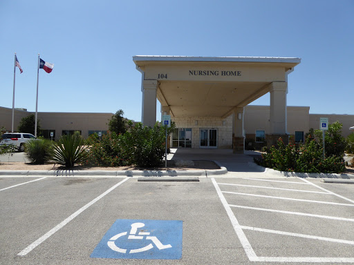 A welcoming entrance with designated handicap parking, set against a clear blue sky.