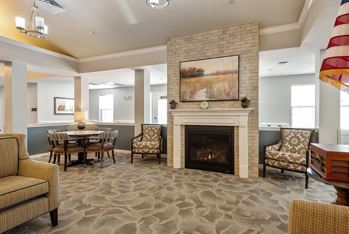 A cozy living room featuring a fireplace and comfortable seating area.