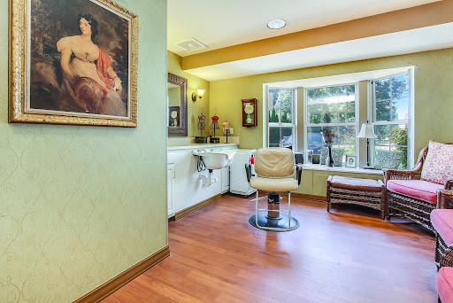 A cozy hair salon featuring stylish decor and a comfortable seating area.