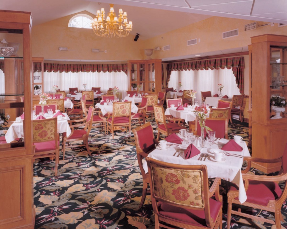 Elegant dining area with beautifully set tables and a chandelier.