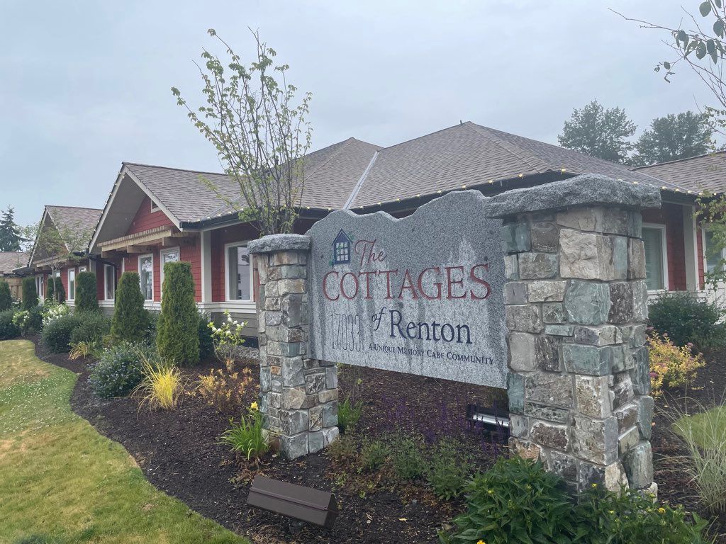 Entrance sign of a residential housing community with landscaped surroundings.