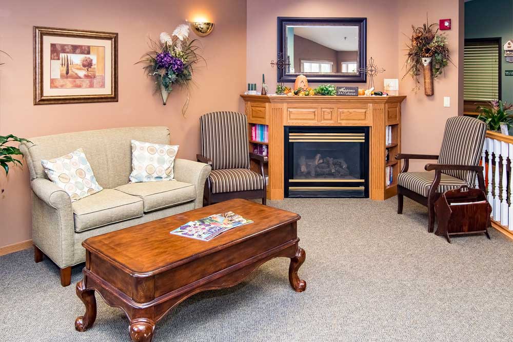 A cozy living room with a sofa, coffee table, and fireplace.