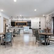 Modern cafe dining area with tables and chairs.