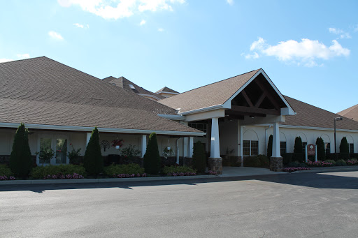 A welcoming commercial building with a landscaped entrance and clear blue skies.