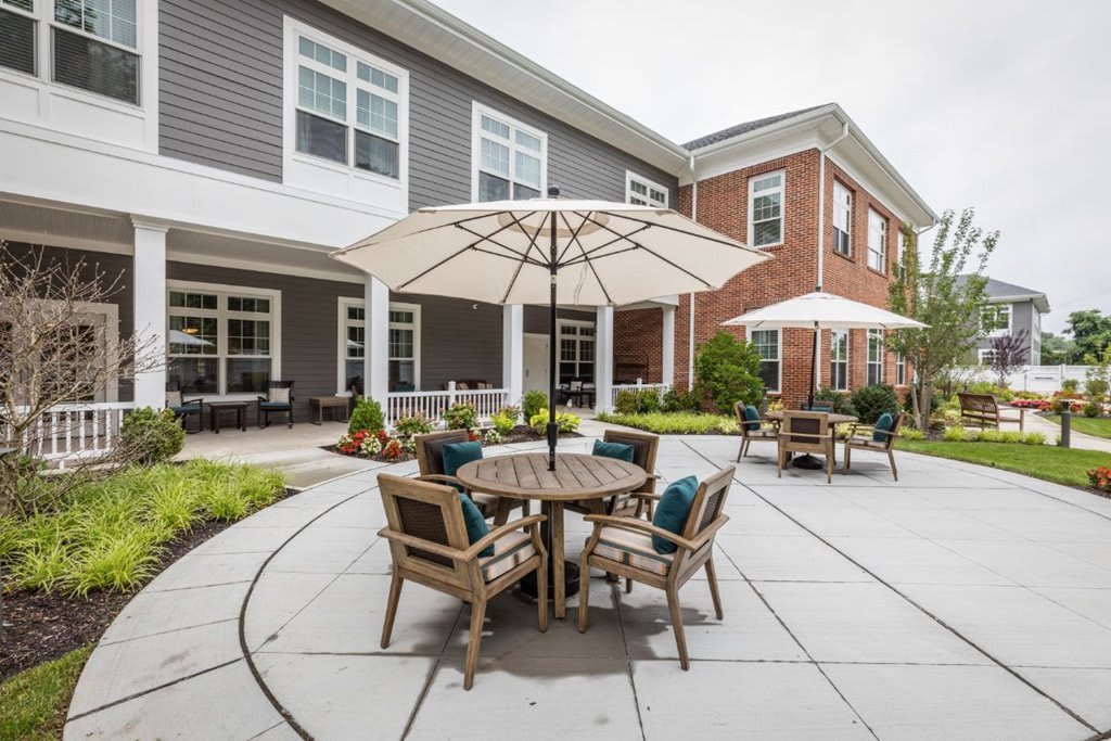 A well-furnished outdoor patio area in a building courtyard.