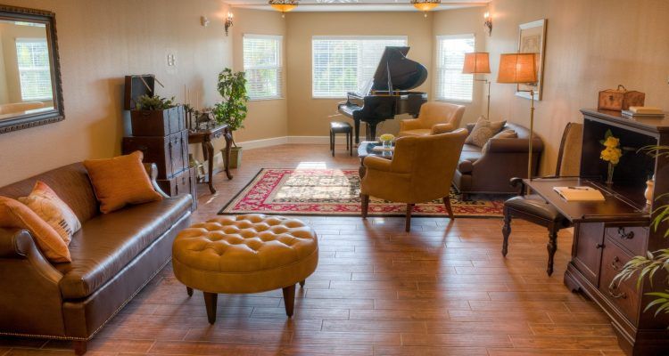 A cozy living room with a grand piano and modern decor.