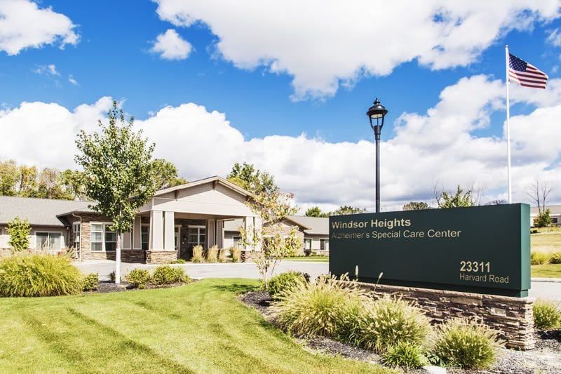 Exterior view of a healthcare facility with a well-maintained lawn and clear skies.