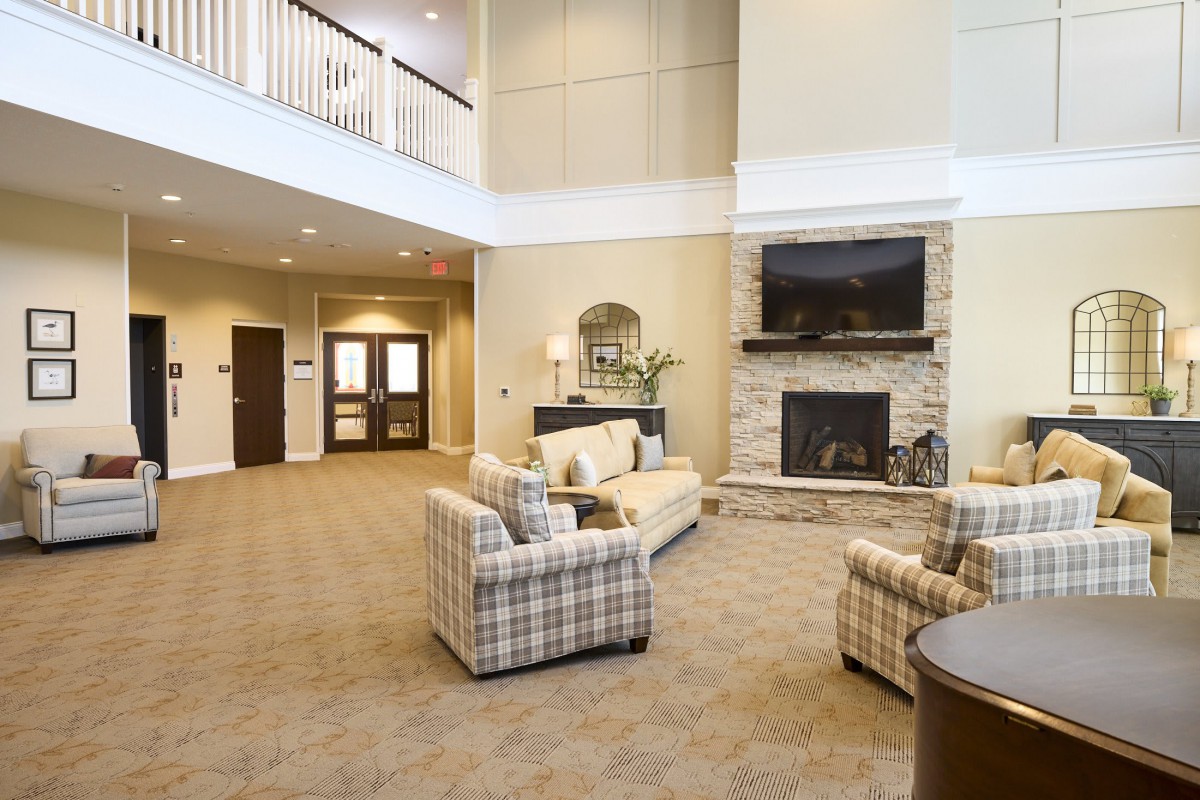 A cozy living room with a fireplace, comfortable seating, and elegant decor.