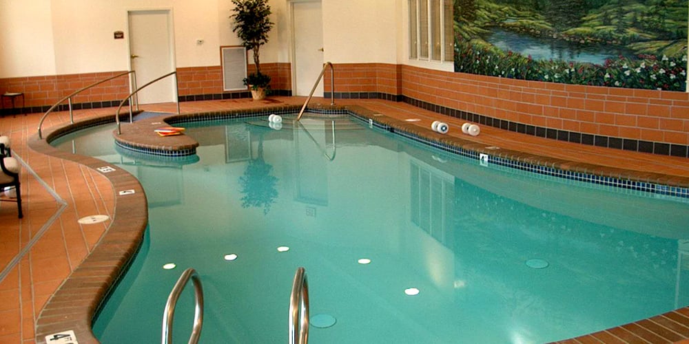 An inviting indoor swimming pool area with clear water and a relaxing atmosphere.