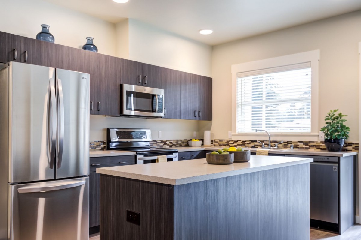A modern kitchen with stainless steel appliances and a sleek design.