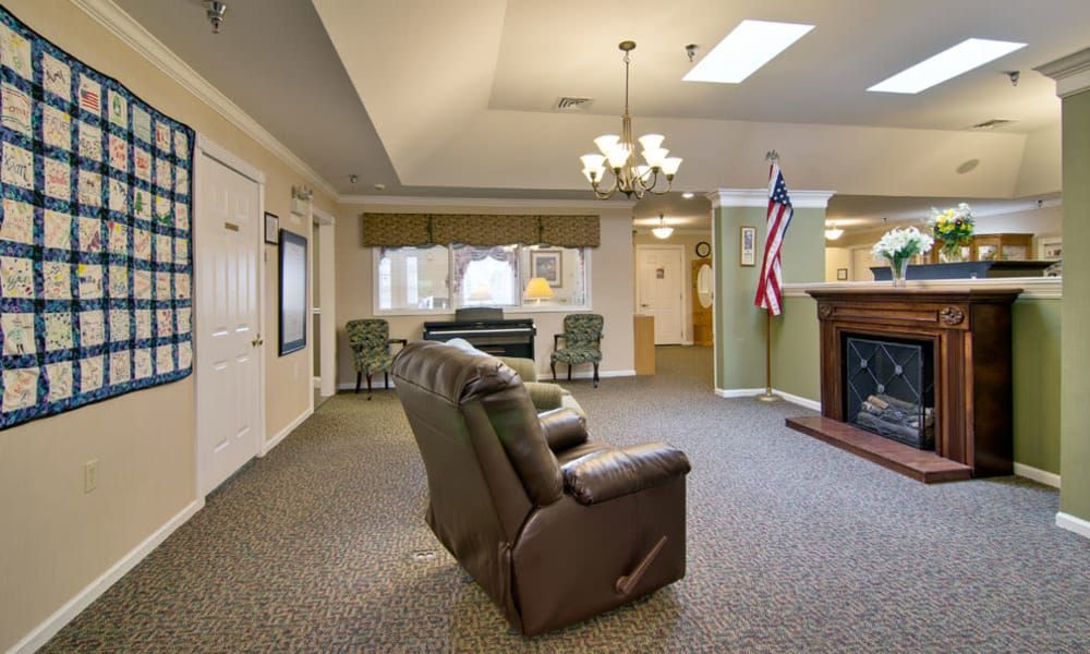 A cozy living room with a recliner, fireplace, and American flag display.