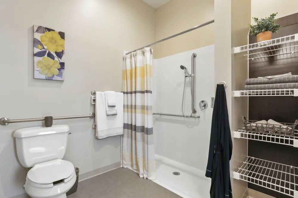 An accessible bathroom with a walk-in shower and grab bars.