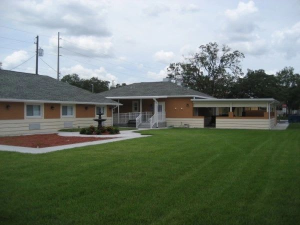 A suburban house with a well-maintained lawn and a clear sky.