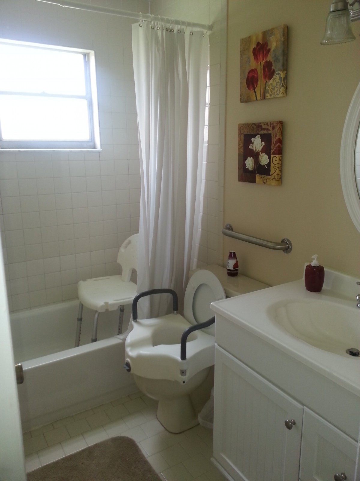 A small bathroom with a toilet, sink, and shower with a curtain.