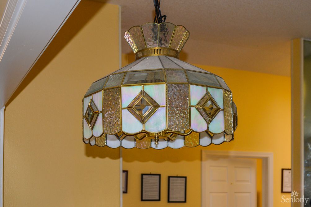 A stained glass hanging lamp with a classic design illuminates the room with its decorative touch.