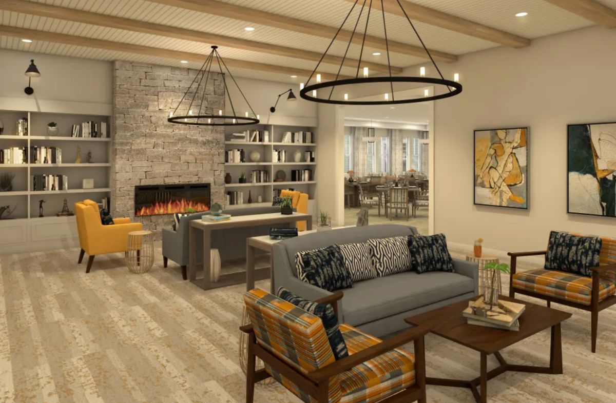 A modern and cozy living room with a fireplace and elegant chandeliers.