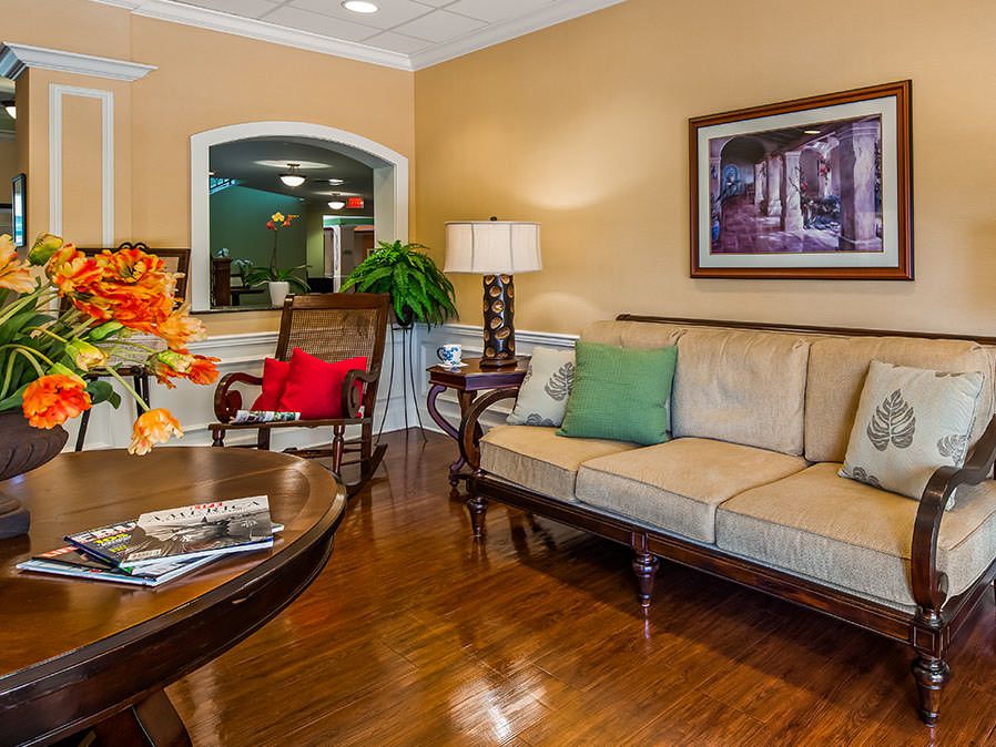 A cozy living room with a comfortable sofa, colorful pillows, and warm lighting.