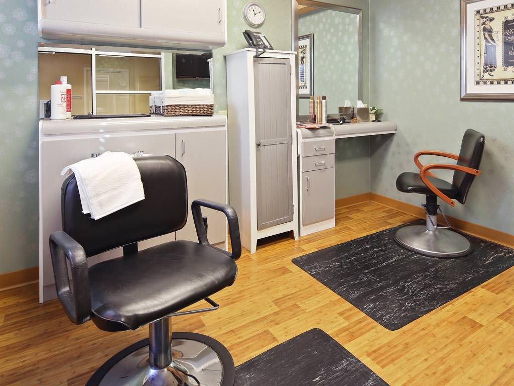 Interior view of a hair salon featuring barber chairs and mirrors.