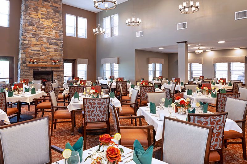 A beautifully decorated dining area with elegant table settings and chandeliers.