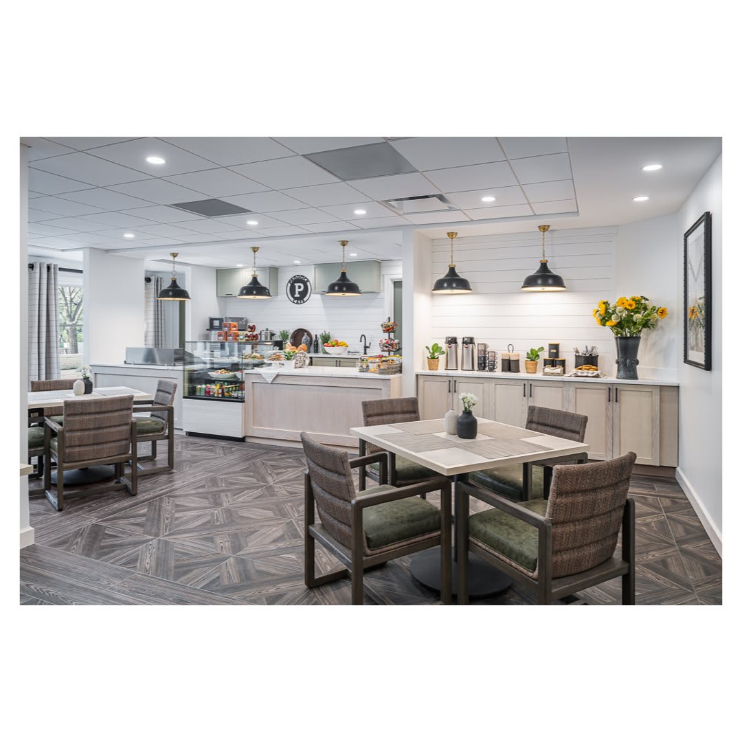 A modern dining area with sleek tables and chairs, stylish lighting fixtures, and a welcoming ambiance.