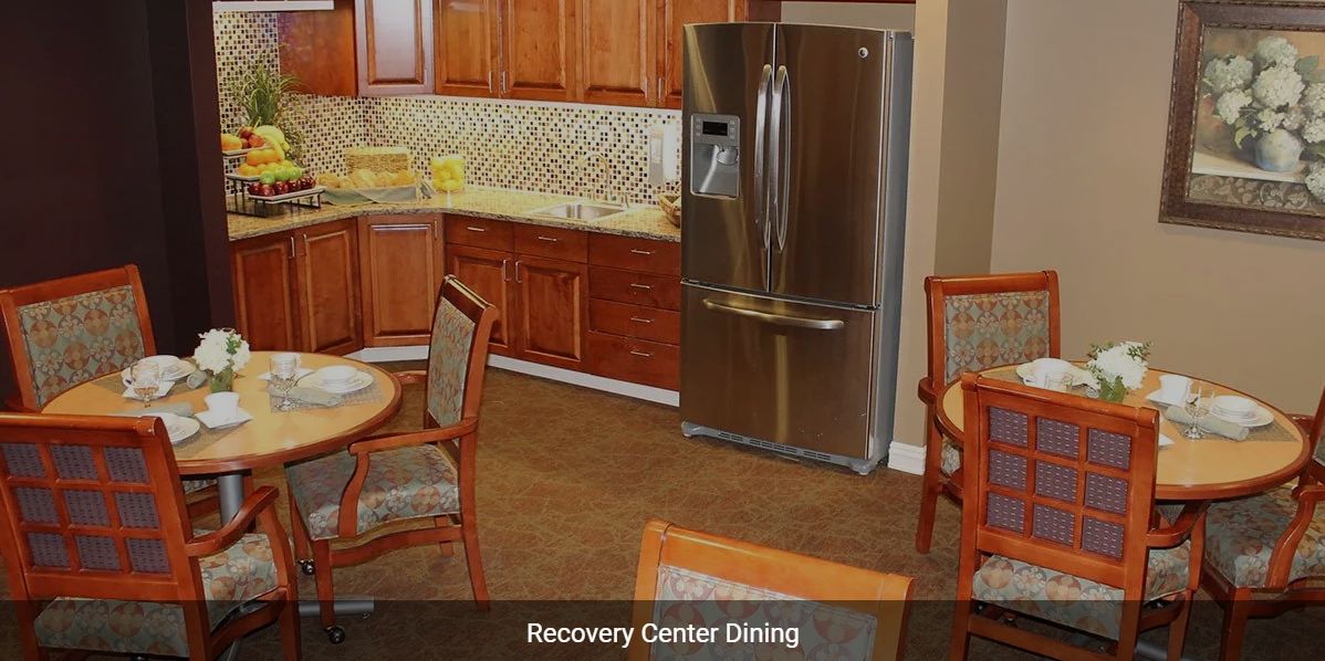 A cozy kitchen and dining area with wooden cabinets and a modern refrigerator.