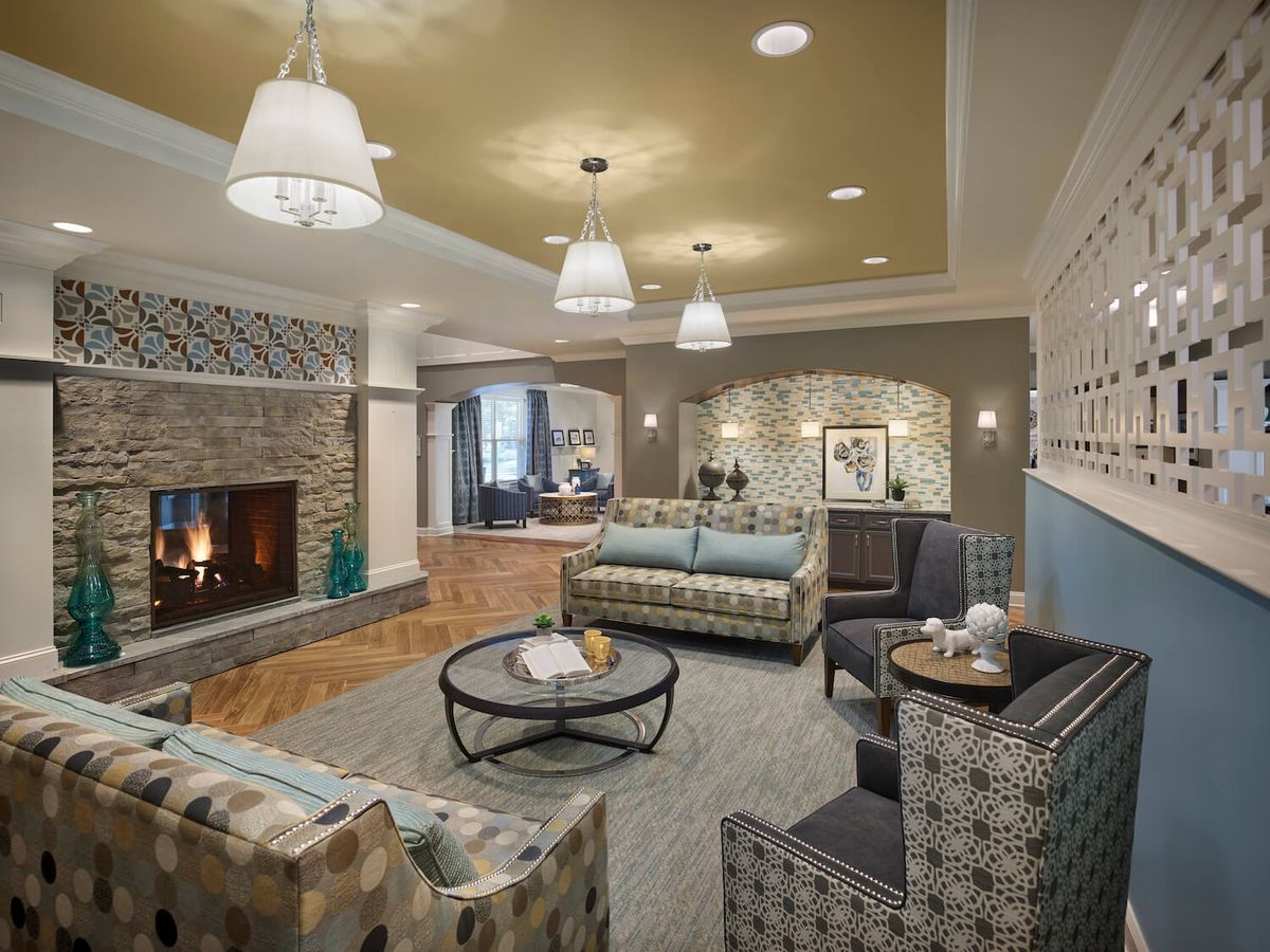 A modern and cozy living room with comfortable seating, a fireplace, and tasteful lighting.