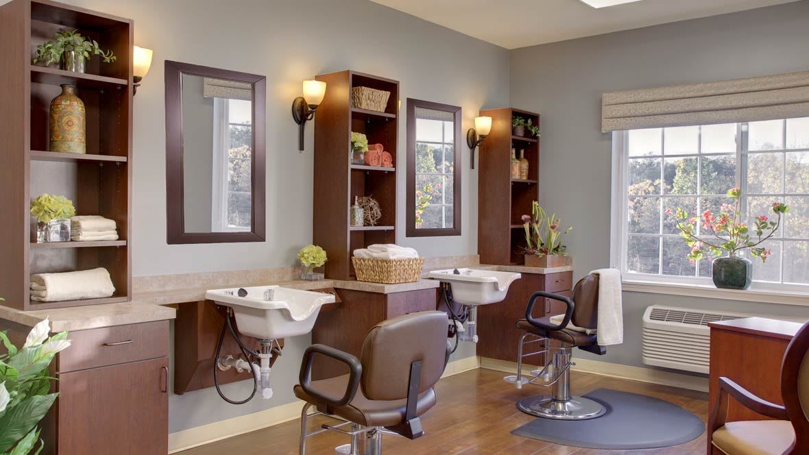 A modern hair salon interior with styling chairs, mirrors, and sinks.