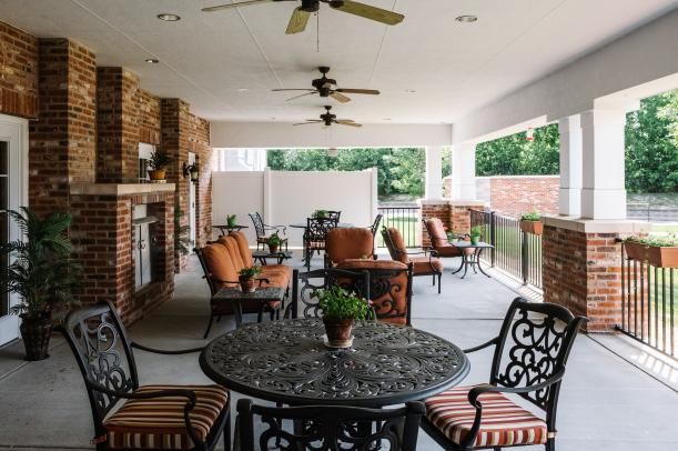 A spacious patio with comfortable seating and ceiling fans.