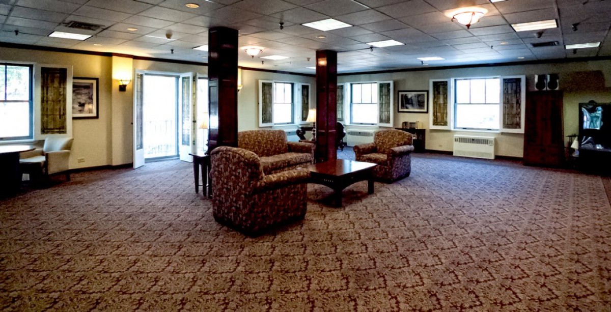 A spacious lobby with comfortable seating and carpeted flooring.