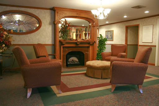 A cozy living room with comfortable seating, a fireplace, and warm decor.