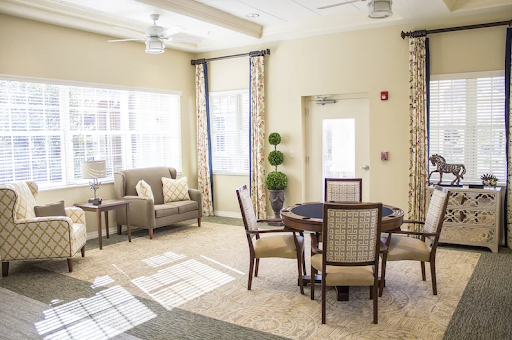 A cozy and inviting living space with natural light, featuring a seating area and a dining table.