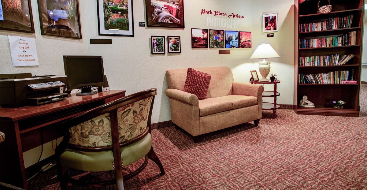 Cozy living room with a sofa, armchair, and decorative elements on the wall.