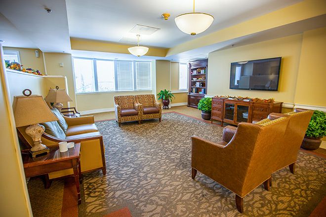 A cozy and well-lit living room with comfortable seating and modern decor.
