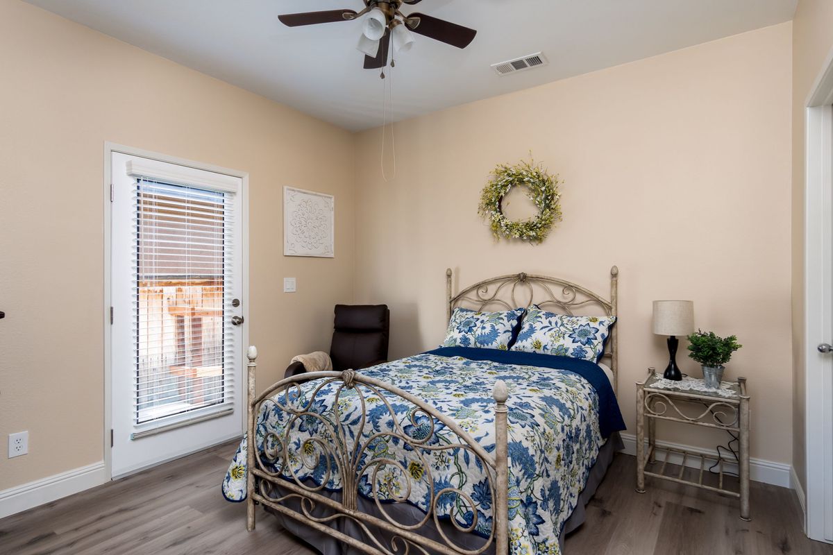 A cozy bedroom with floral bedding and simple decor.