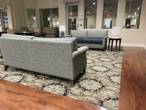A cozy lounge area featuring patterned sofas and a decorative rug.