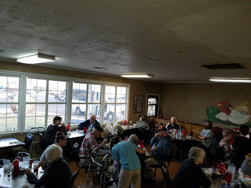 A cozy dining space filled with people enjoying a meal together.