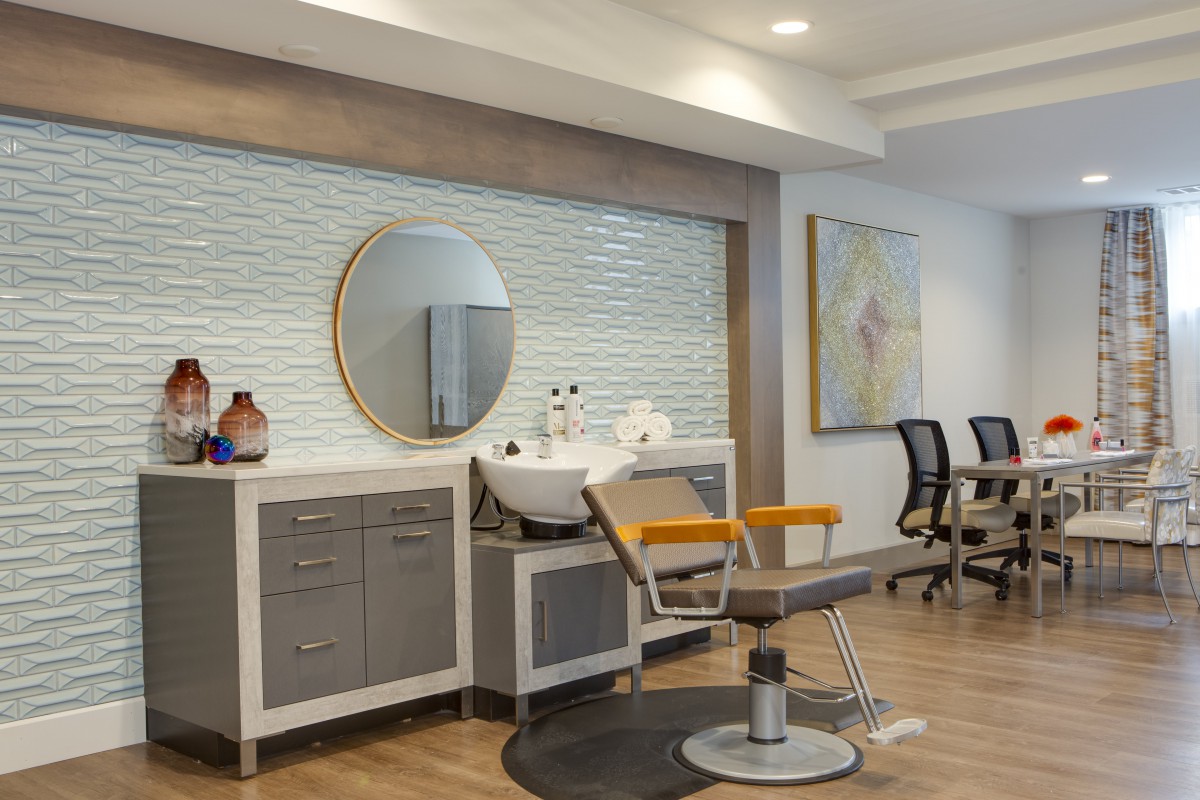 A modern salon interior featuring a barber chair and styling station.