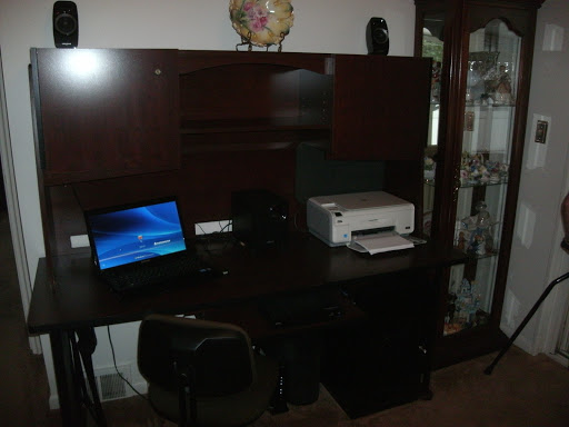 A cozy office setup featuring a desk with a computer and printer.
