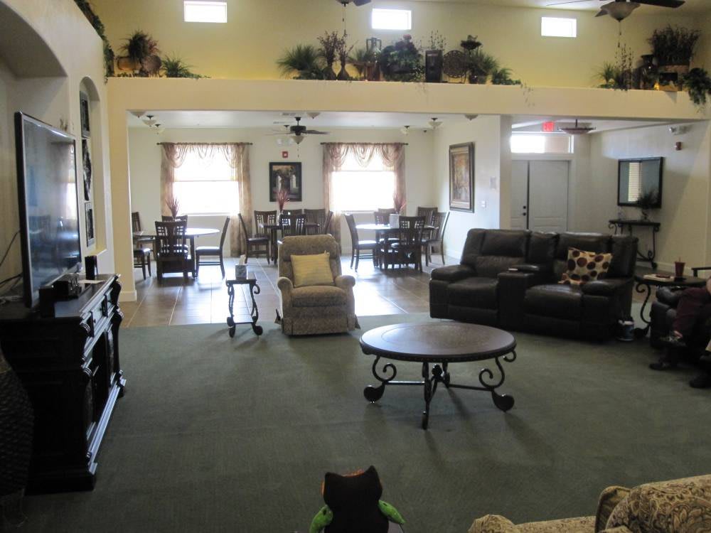 A spacious living room with sofas, tables, and decorative elements.