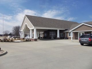 A suburban residential house with a large garage and driveway.