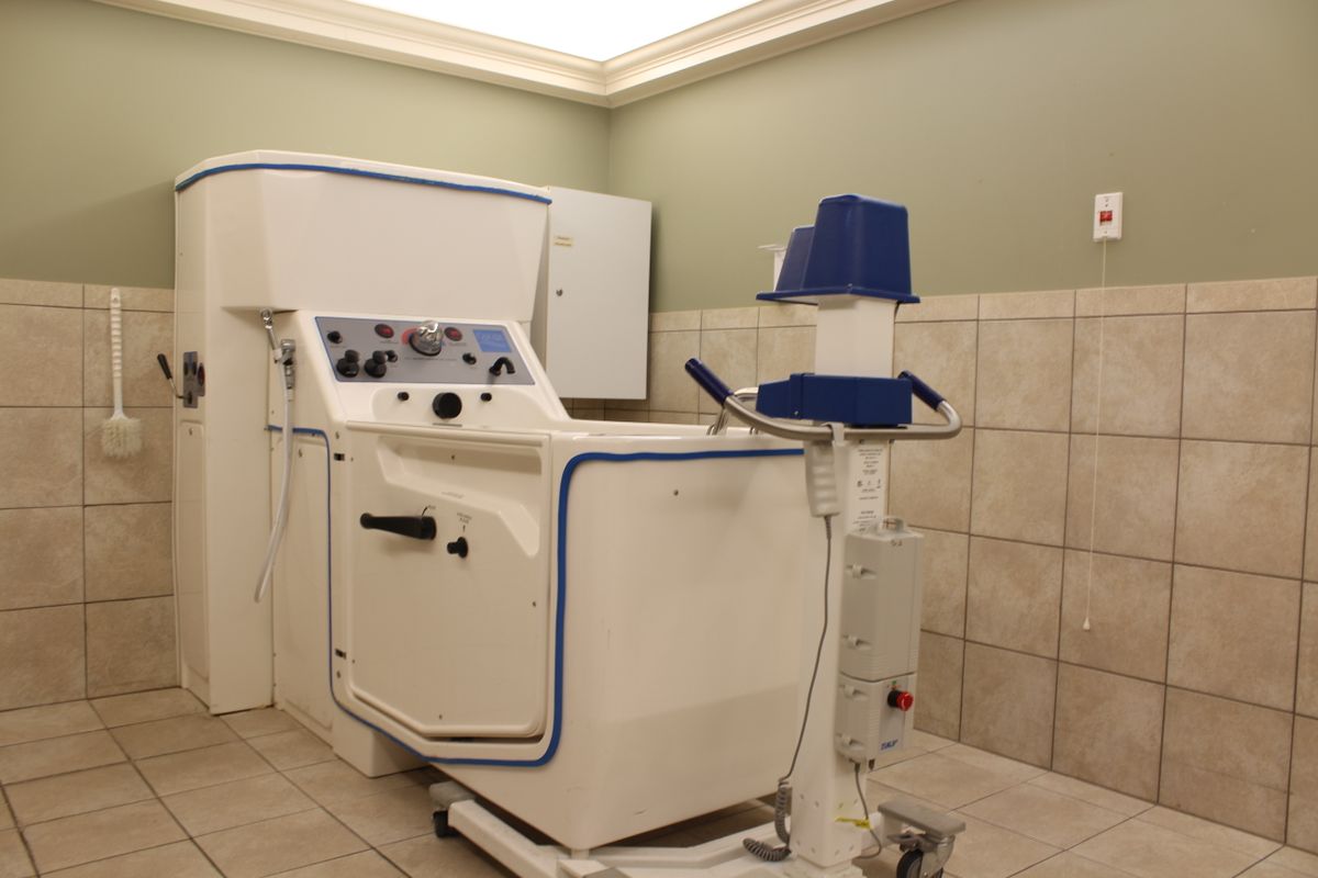 A hydrotherapy machine in a hospital room, used for therapeutic treatments.