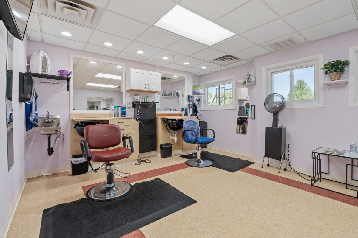 A cozy hair salon with multiple chairs and styling stations.