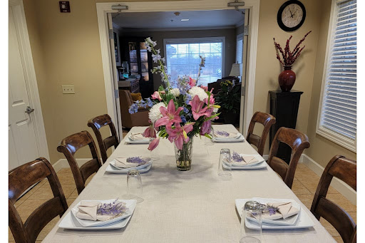 A beautifully arranged dining table with floral centerpiece and elegant tableware.